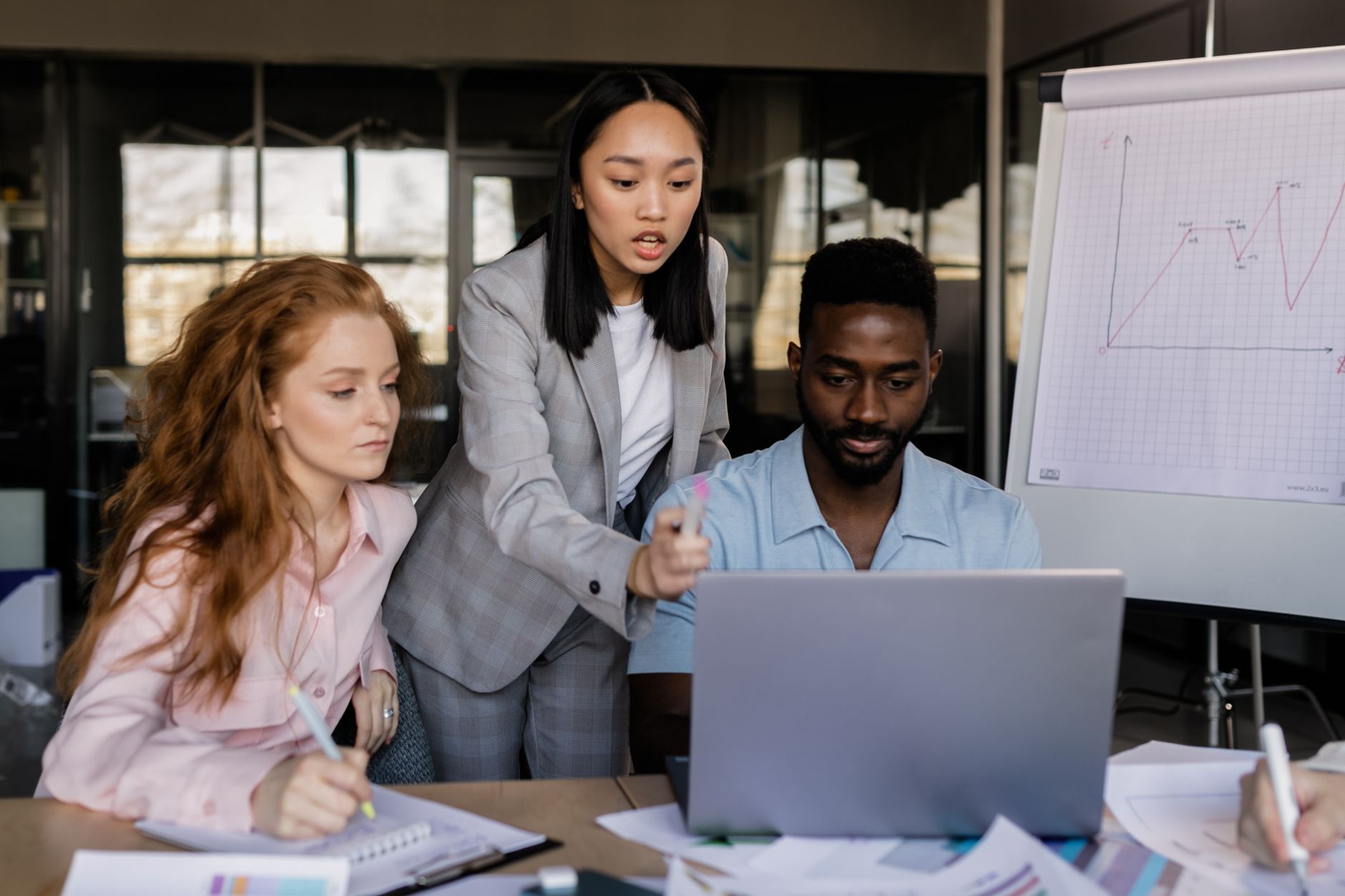 Qualifi Level 3 Diploma in Introduction to Management — Business team discussing strategy in a modern office setting with diverse members.