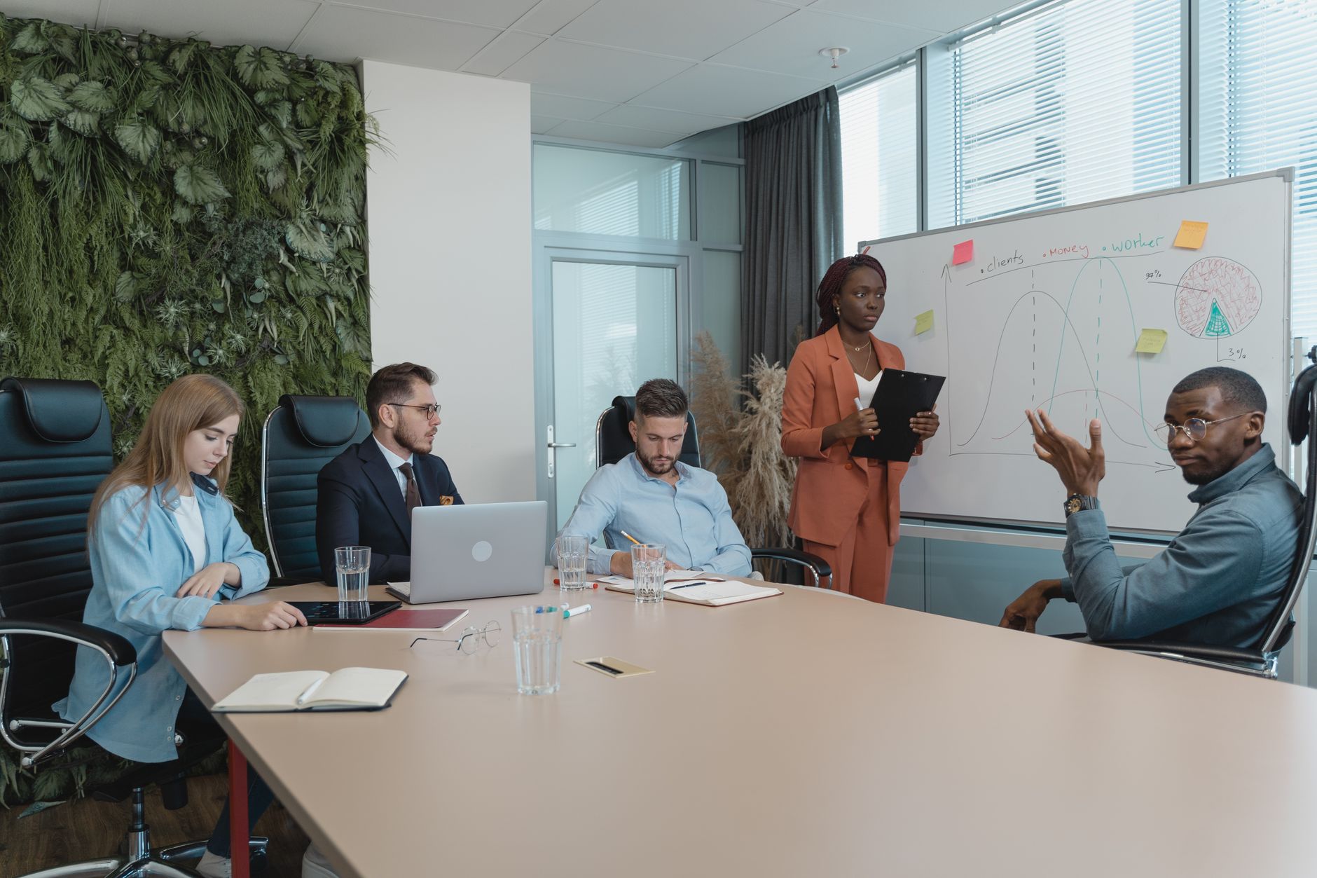 Qualifi Level 4 Diploma in Innovation and Future Foresight — Diverse group of professionals engaged in an innovative brainstorming session in a modern office setting.