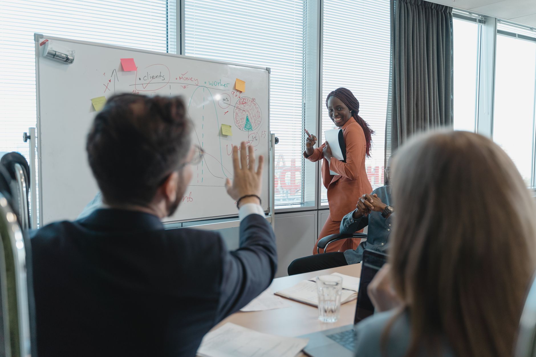 Qualifi Level 7 Diploma in Strategic Management and Innovation — Multicultural business team brainstorming in a modern office setting with a focus on cooperation and teamwork.