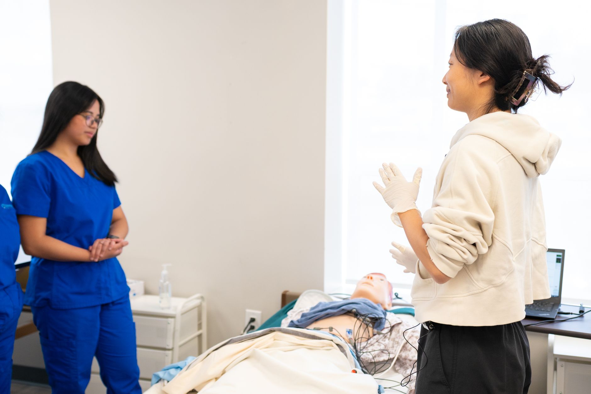 Qualifi Level 3 Diploma in Hospitality and Tourism Management — Nursing students engage in hands-on training with a medical dummy in a clinical setting.
