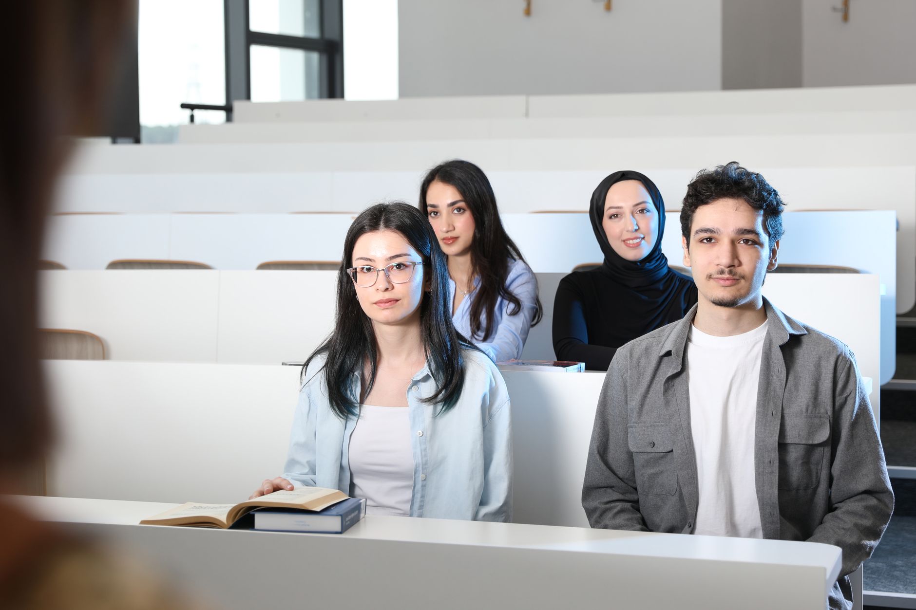 Qualifi Level 7 Diploma in Law — Group of diverse university students attending a class session in a modern lecture hall.