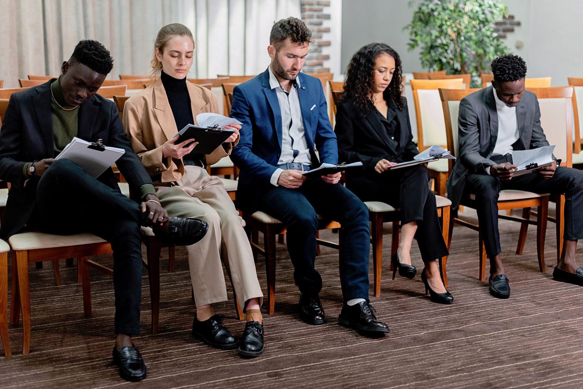 Human Resource Management — A diverse group of business professionals reviewing documents in a meeting setting.
