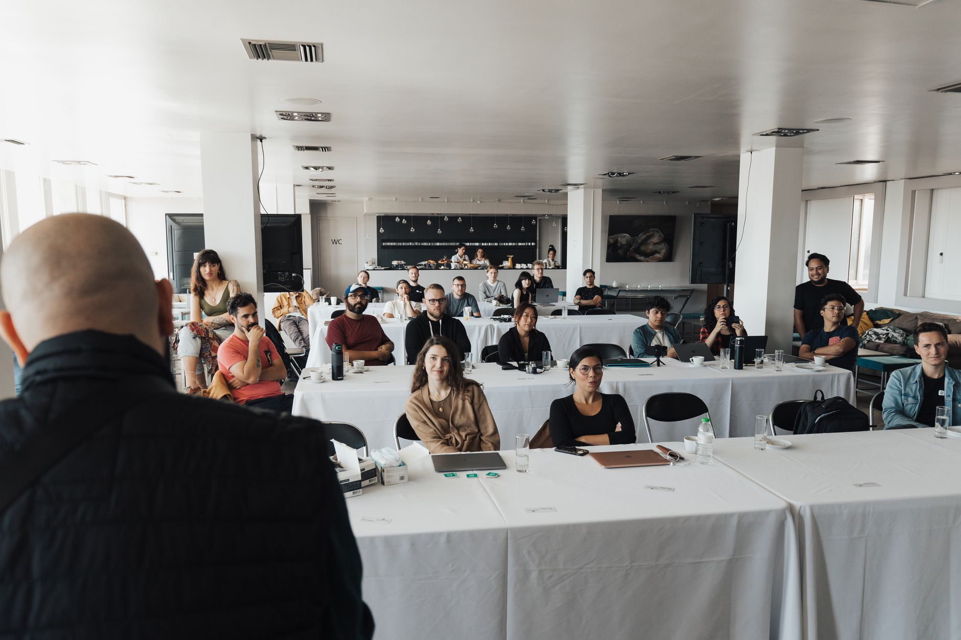 Business Communication — A diverse group of business professionals attending a presentation in a modern conference room.