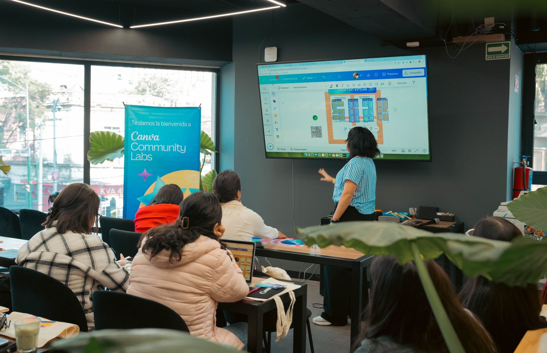 Workplace Welfare — Interactive workshop session at Canva Community Labs with a presentation screen and engaged audience.