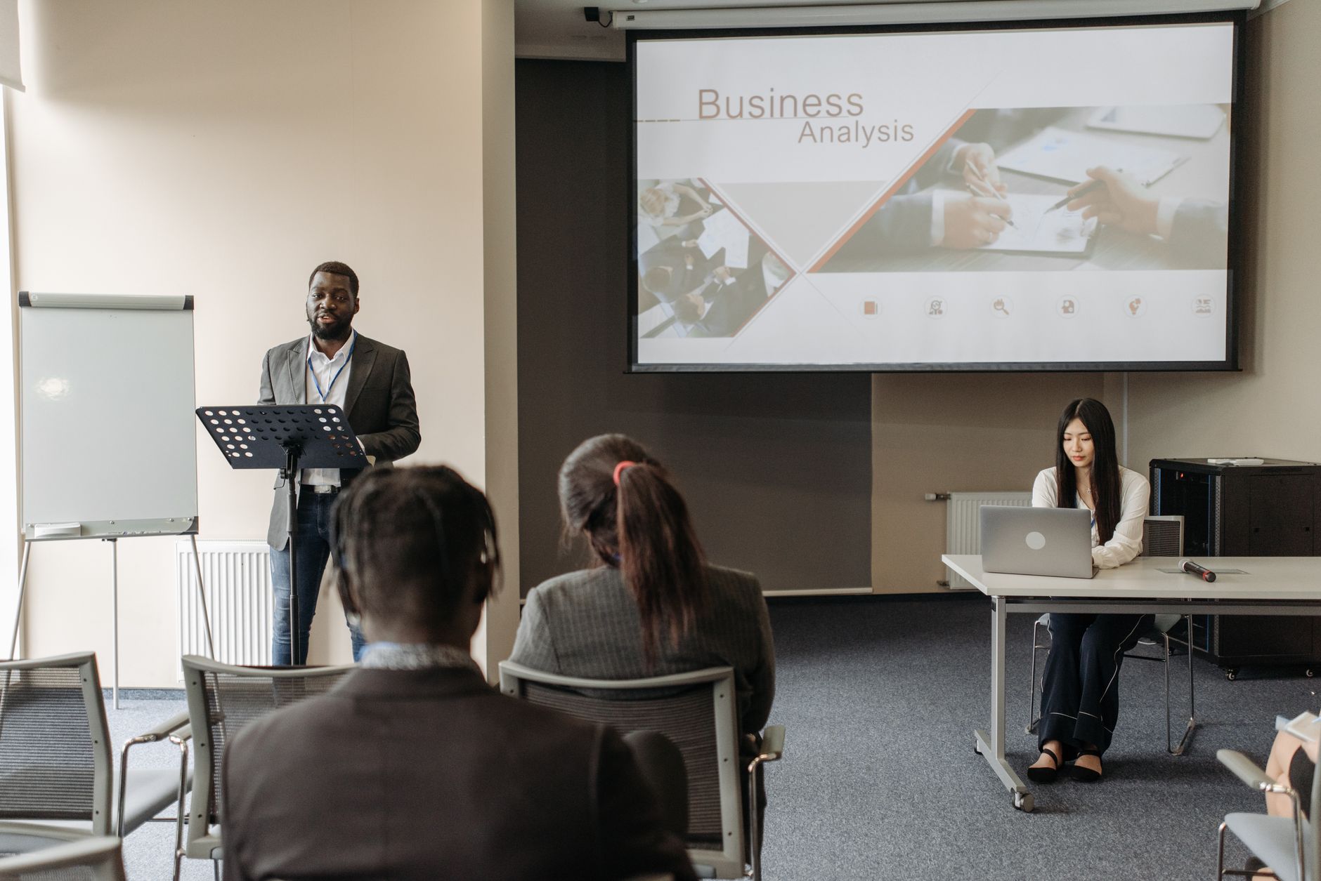An Introduction to Marketing — Business seminar with a speaker and audience in a conference room.