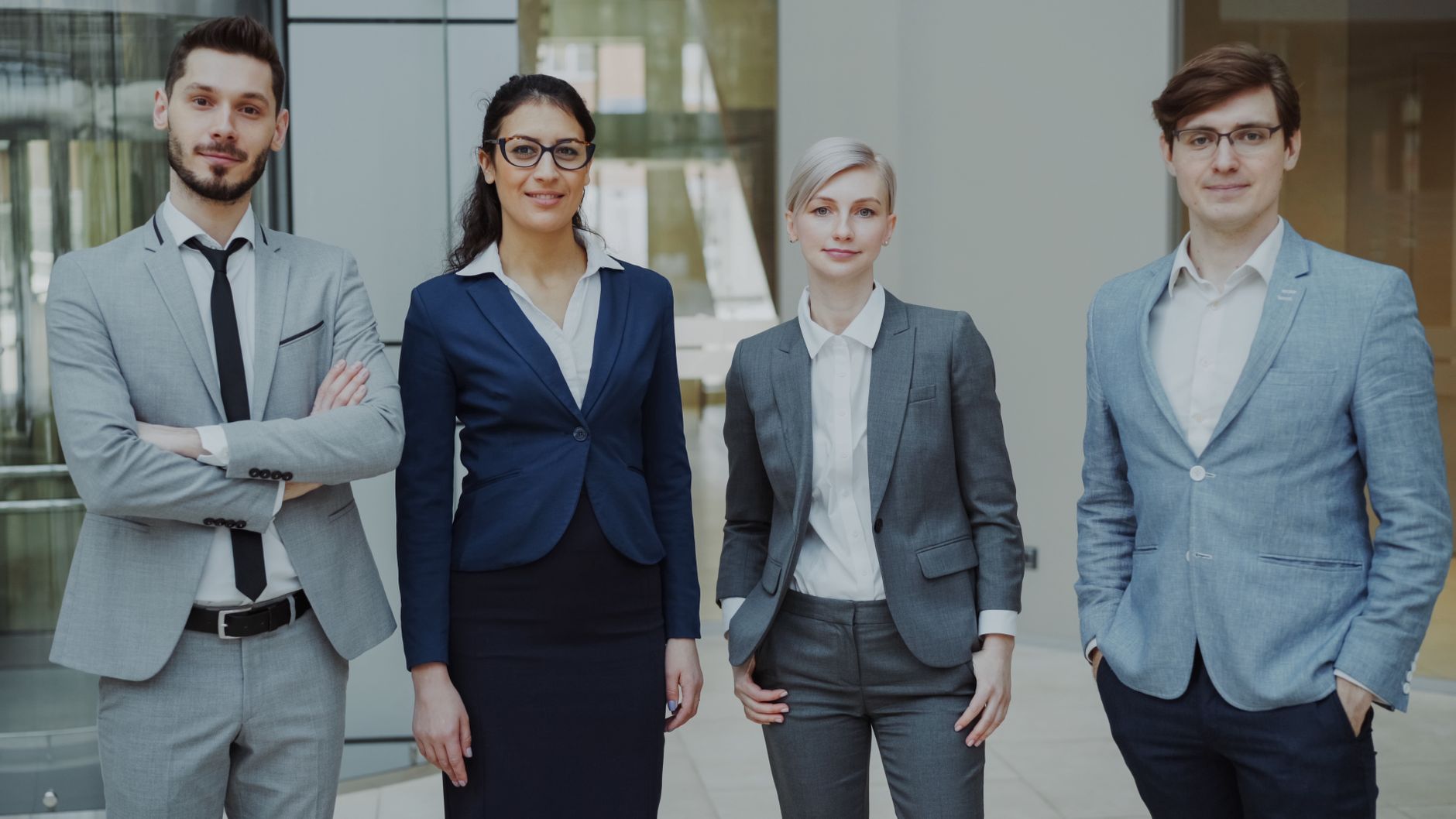 An Introduction to the Business Environment Business Resources — Diverse group of business professionals in an office setting representing corporate teamwork.