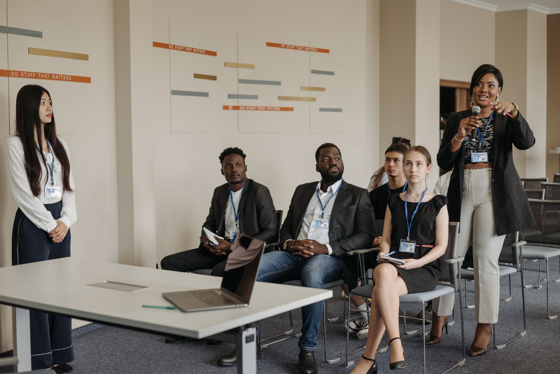 Organisational Culture — A diverse group of professionals attending a business seminar, actively participating and engaging in discussions.