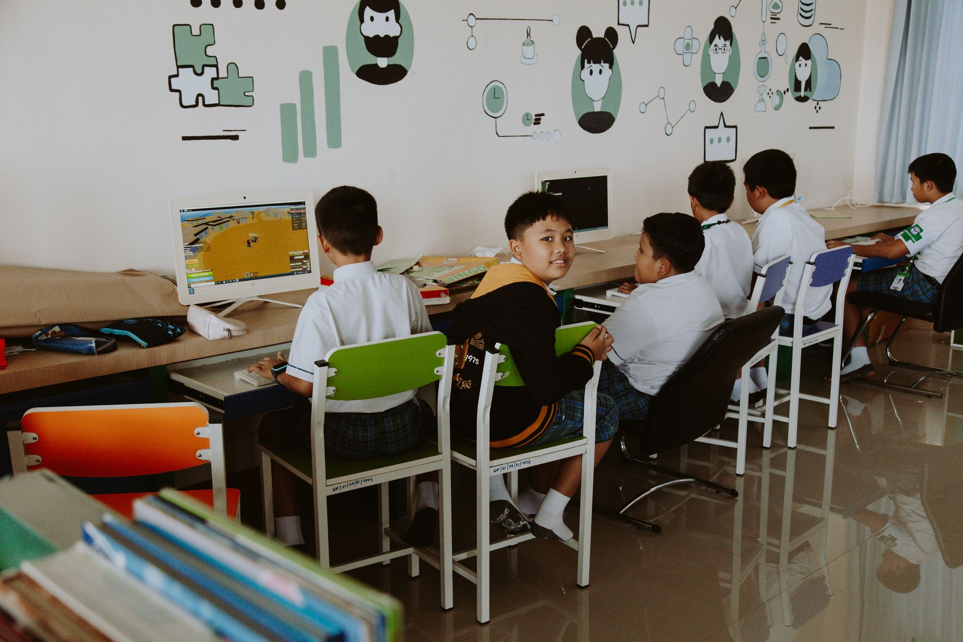 and then choose their subject area to complete another 120 credits. Units — Elementary school students learning in a tech-driven, modern classroom setting.