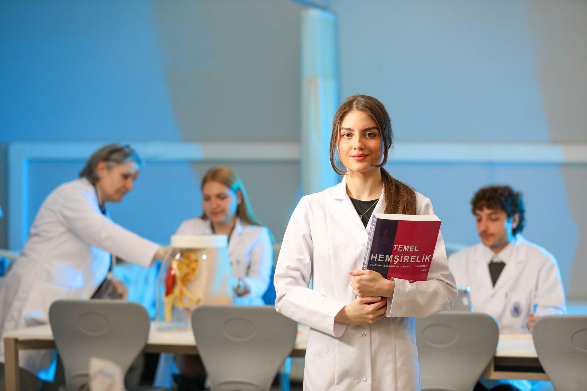 Qualifi Level 5 Extended Diploma in Hospitality and Tourism Management — Young nursing students engaging in lab study, showcasing medical education.