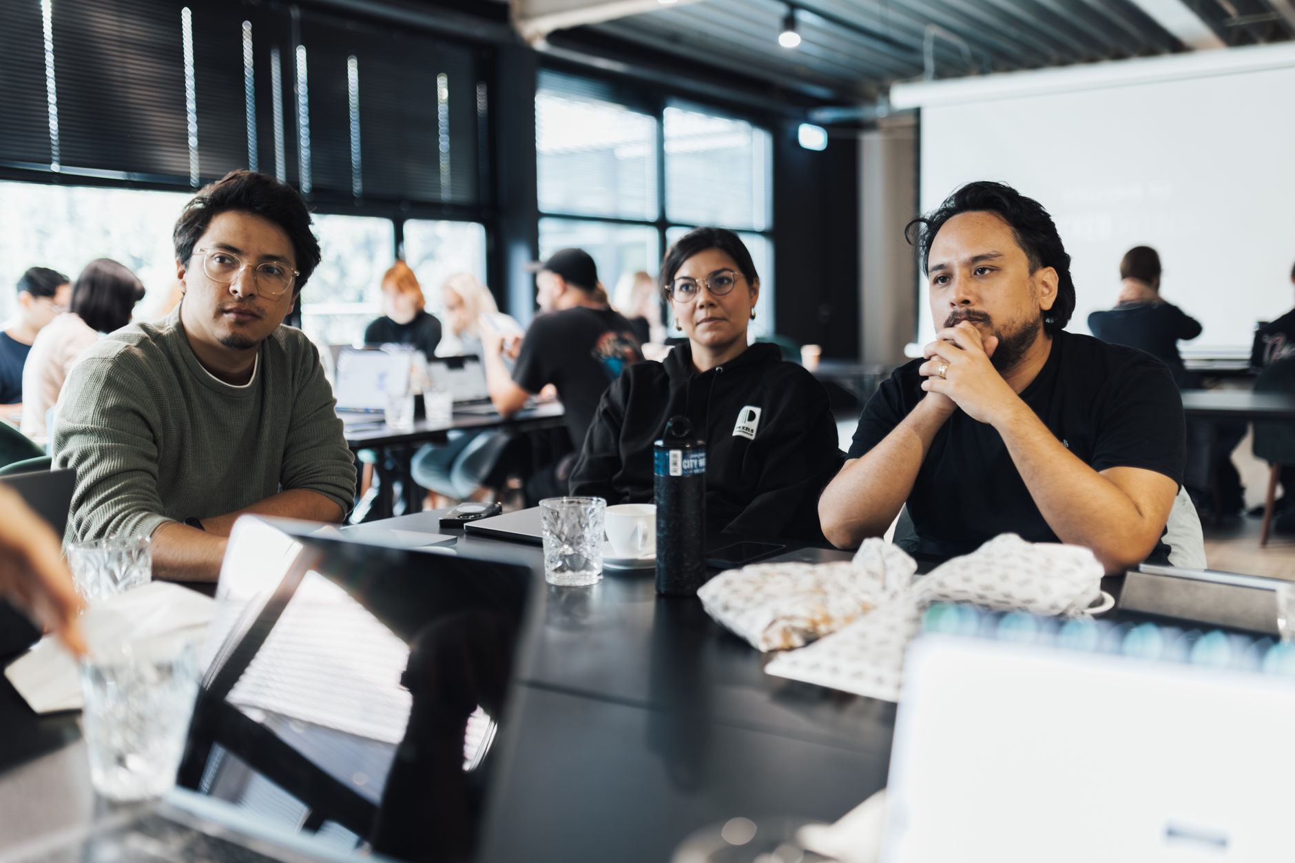 An Introduction to Marketing — Professionals engaged in a meeting in a modern office space discussing business strategies.