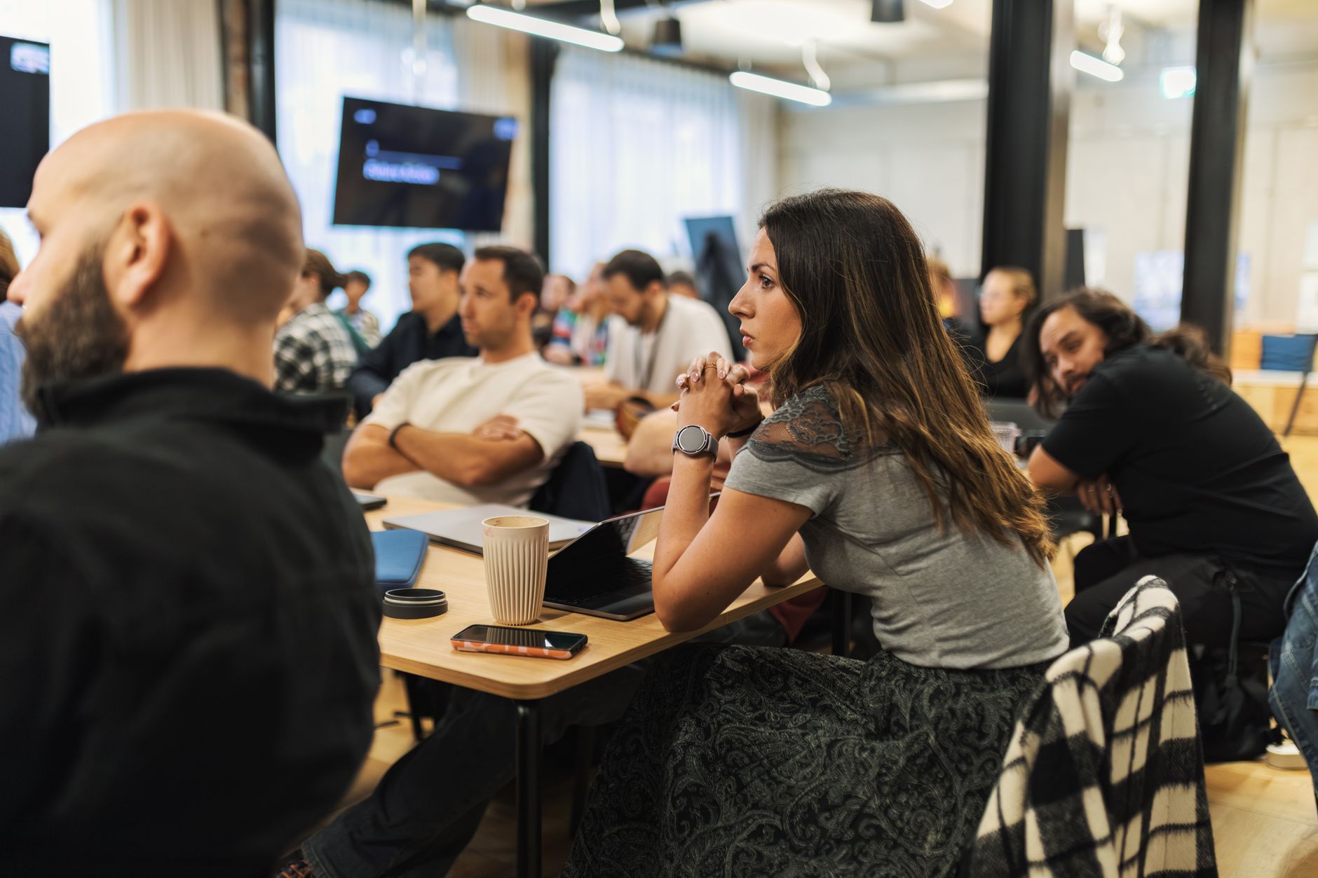 Managing Business Operations — Adults engaged in a business meeting in a modern, inviting office environment.