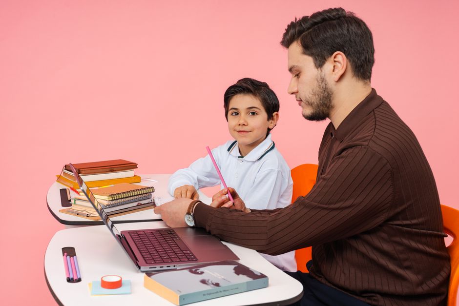 Qualifi Level 3 Diploma in Specialist Support for Teaching and Learning in Schools — A teacher assists a student in a colorful classroom setting, fostering learning and education.