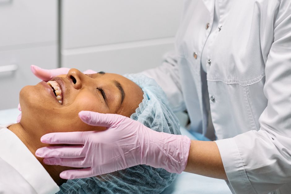Qualifi Level 5 Advanced Diploma in Aesthetic Practice — A client receiving a relaxing facial treatment at a modern spa clinic.