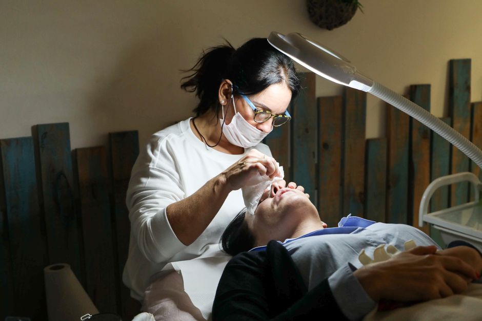 Qualifi Level 6 Award in Advanced Aesthetic Procedures: Skin Boosters — Esthetician provides a detailed facial treatment to a client in a spa setting.