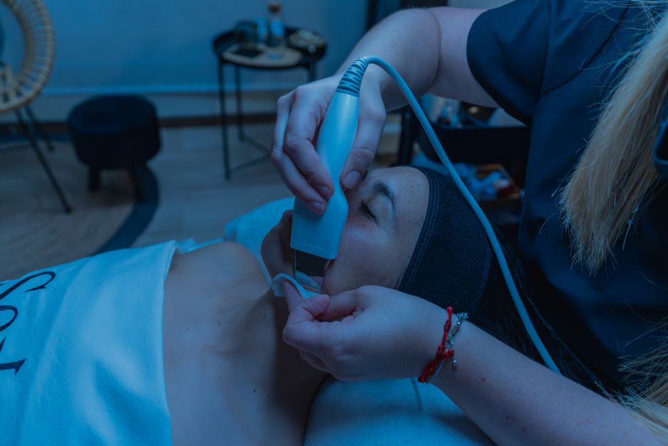 Qualifi Level 3 Diploma in Advanced Beauty Therapy — Close-up of a skincare treatment using advanced device in a spa setting.