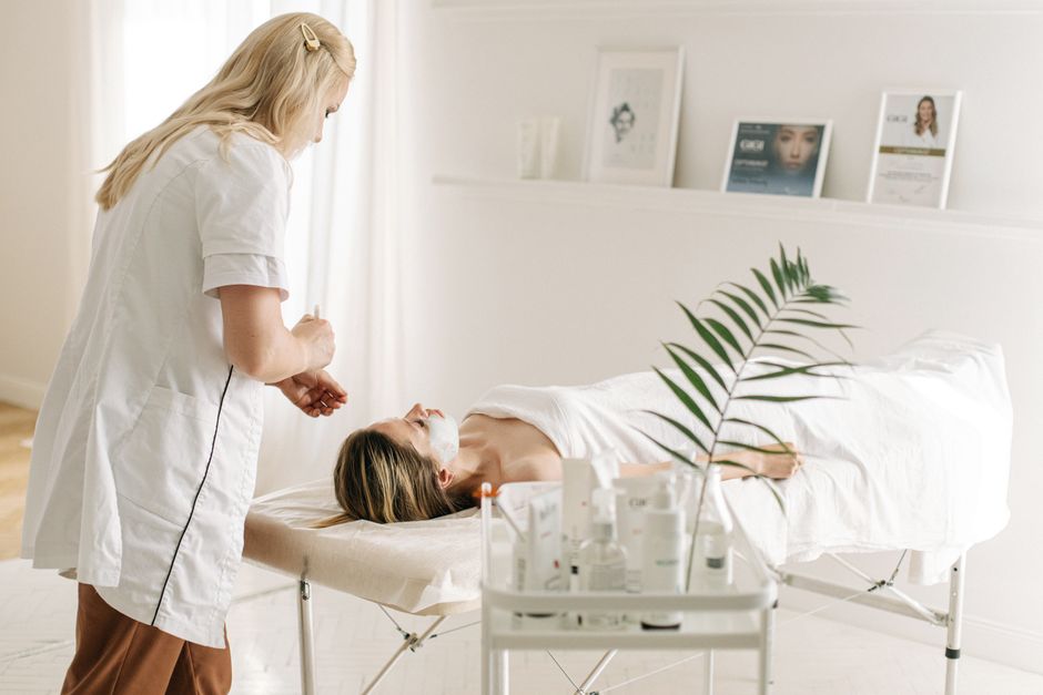 Qualifi Level 3 Certificate in Advanced Lashes and Brow Lamination — A serene spa setting featuring a facial treatment with a professional beautician, highlighting relaxation and skincare.