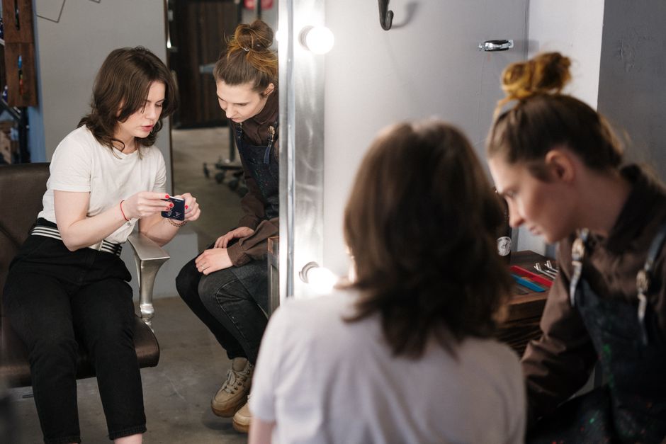Qualifi Level 3 Certificate in Spa and Wellness Experiences — Two women engaged in a hair consultation at a salon, reflecting professionalism and style.