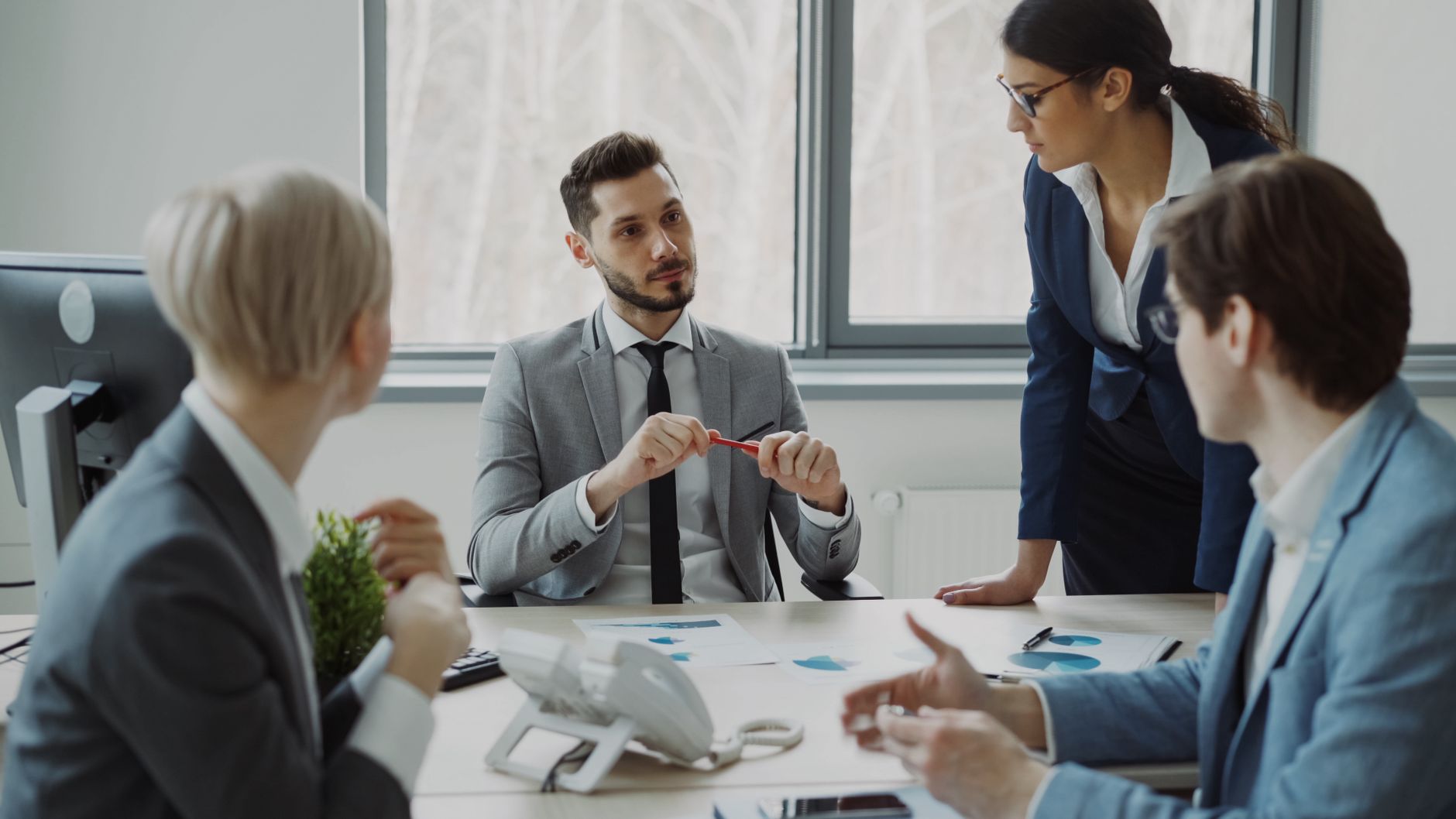 Effective Decision Making — Professional team discussing business strategy in a modern office setting.
