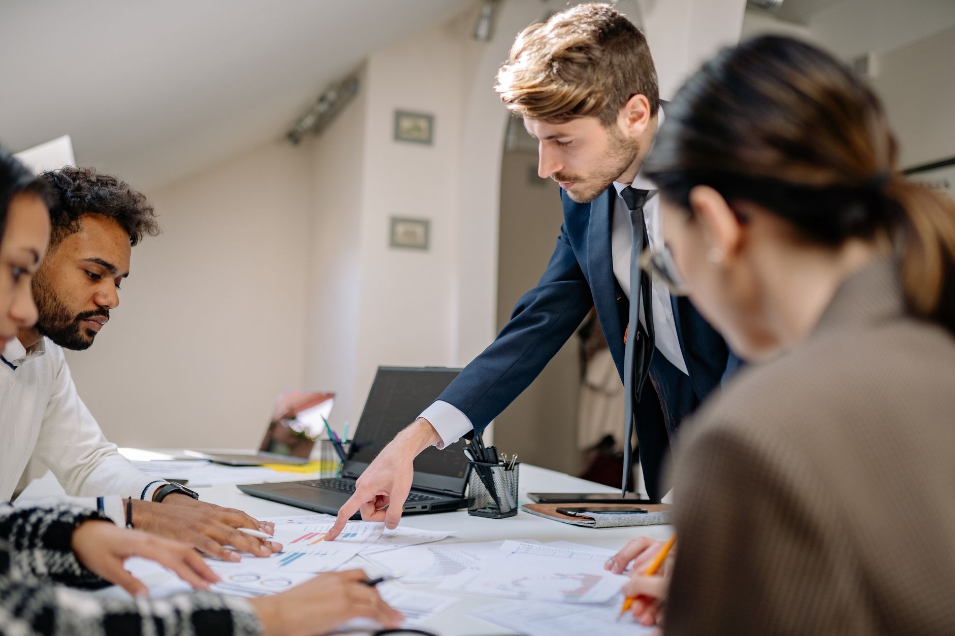 Business Development — A diverse team engaged in a business meeting, fostering collaboration and teamwork in an office setting.