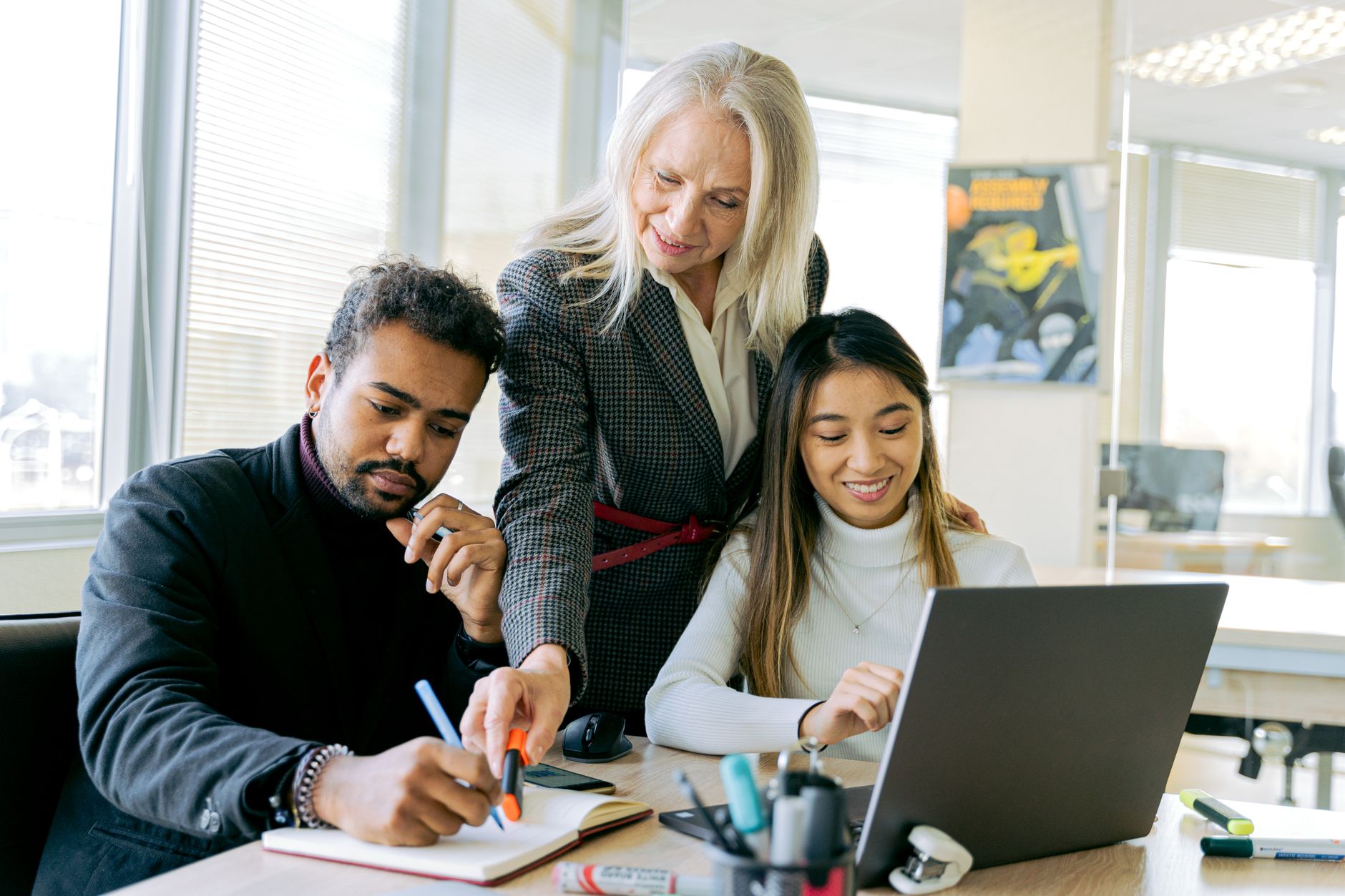 Resourcing, Talent Management and Development — An adult team collaborating in an office environment, focusing on teamwork and diversity.
