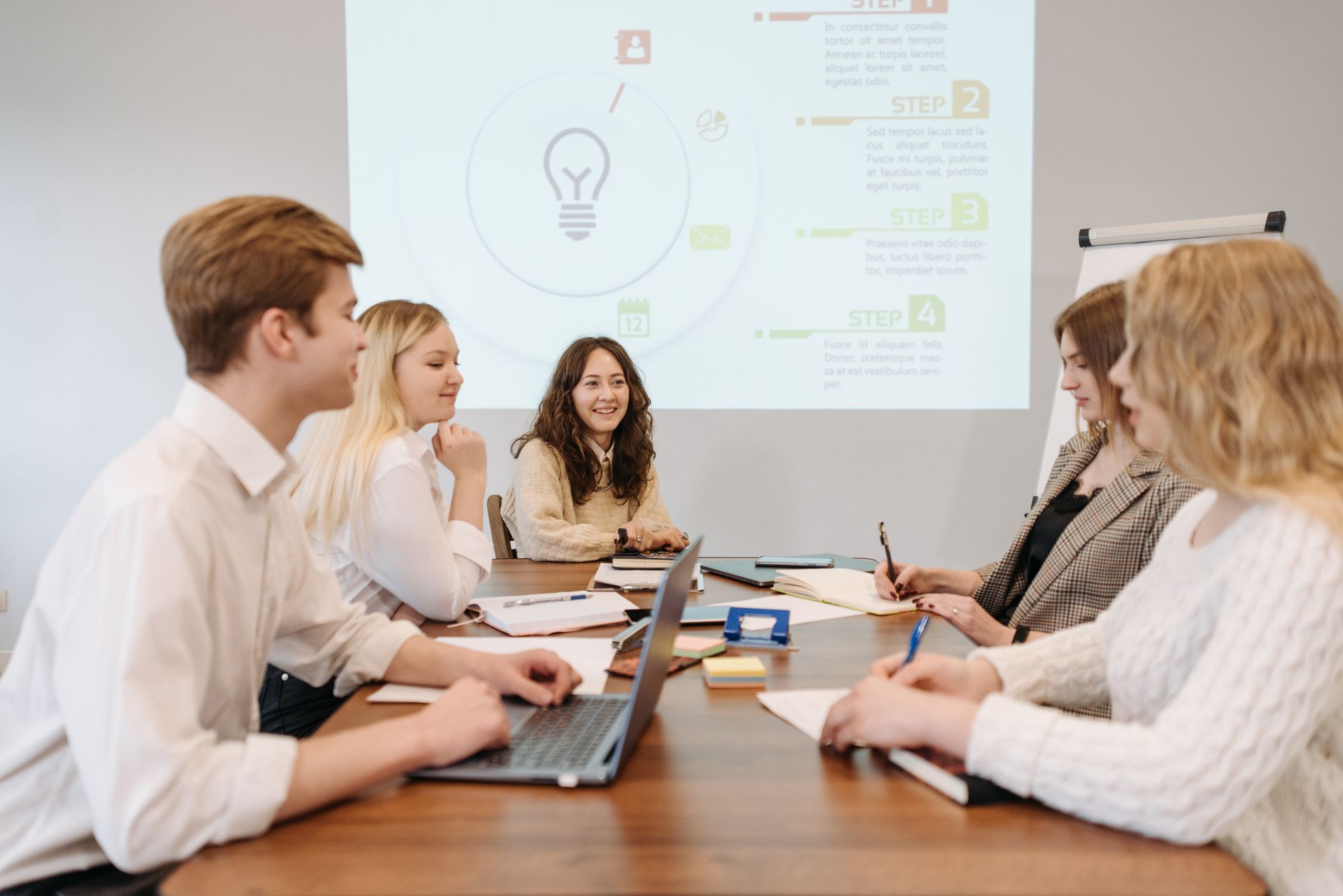 Advanced Strategic Marketing — A diverse team of young professionals engaged in a collaborative meeting in an office setting.