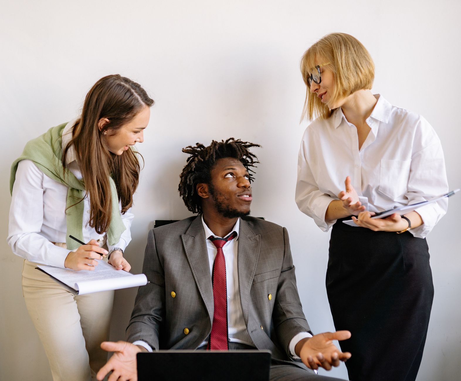 Human Resource Practice, Leadership and Managing People — A diverse team collaborates on business strategy in a modern office setting.