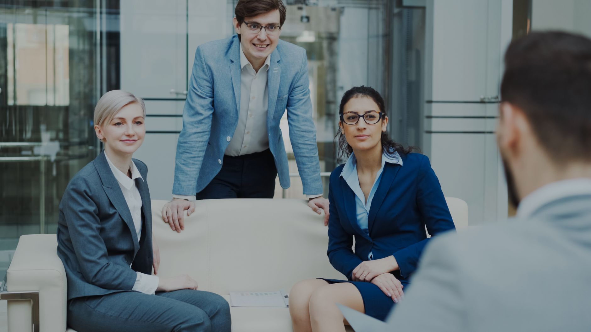 Strategic Management — Professional business team having a meeting inside a modern office environment.