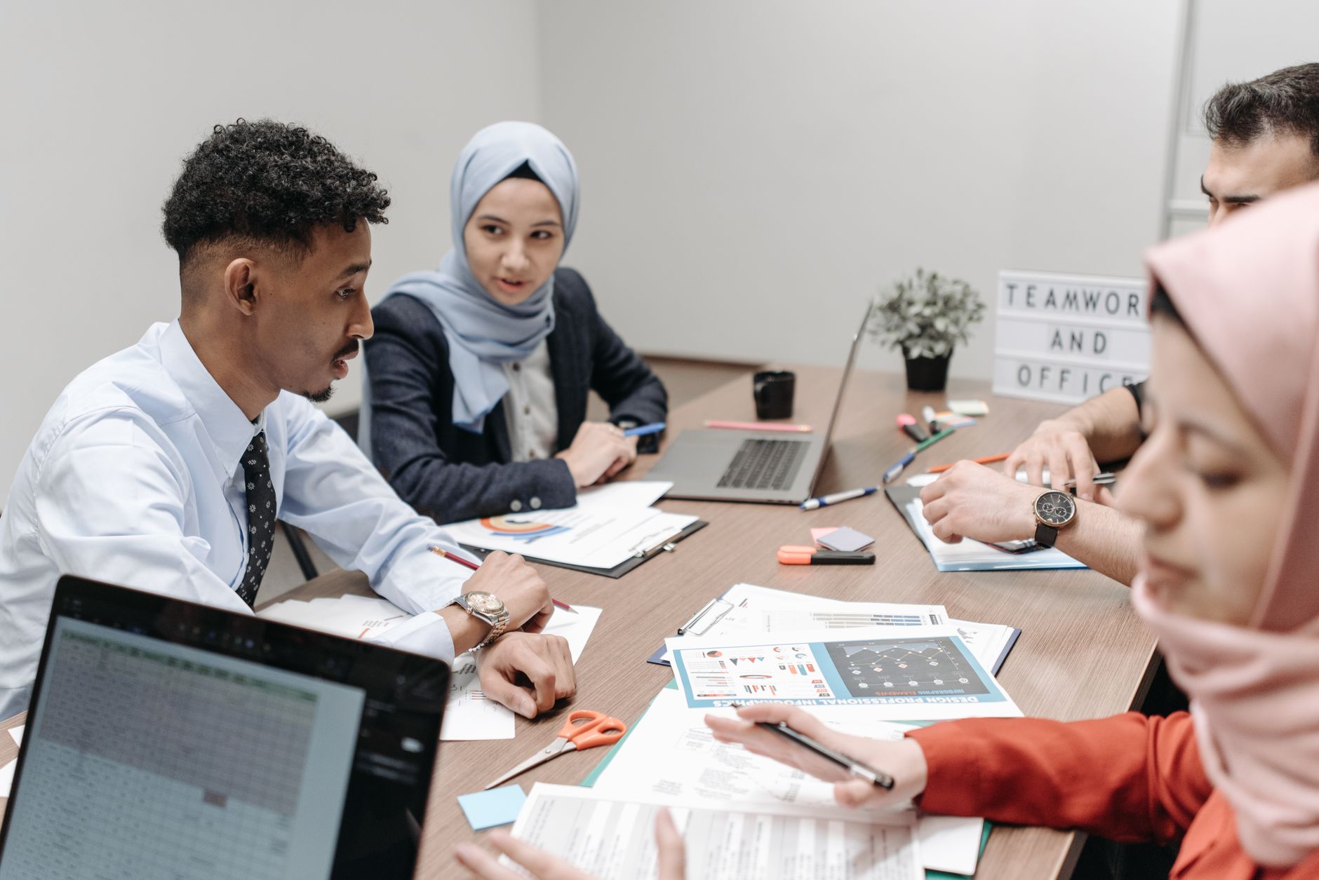 Leading a Strategic Management Project — A diverse group of professionals collaborating in an office setting, focusing on teamwork and discussion.