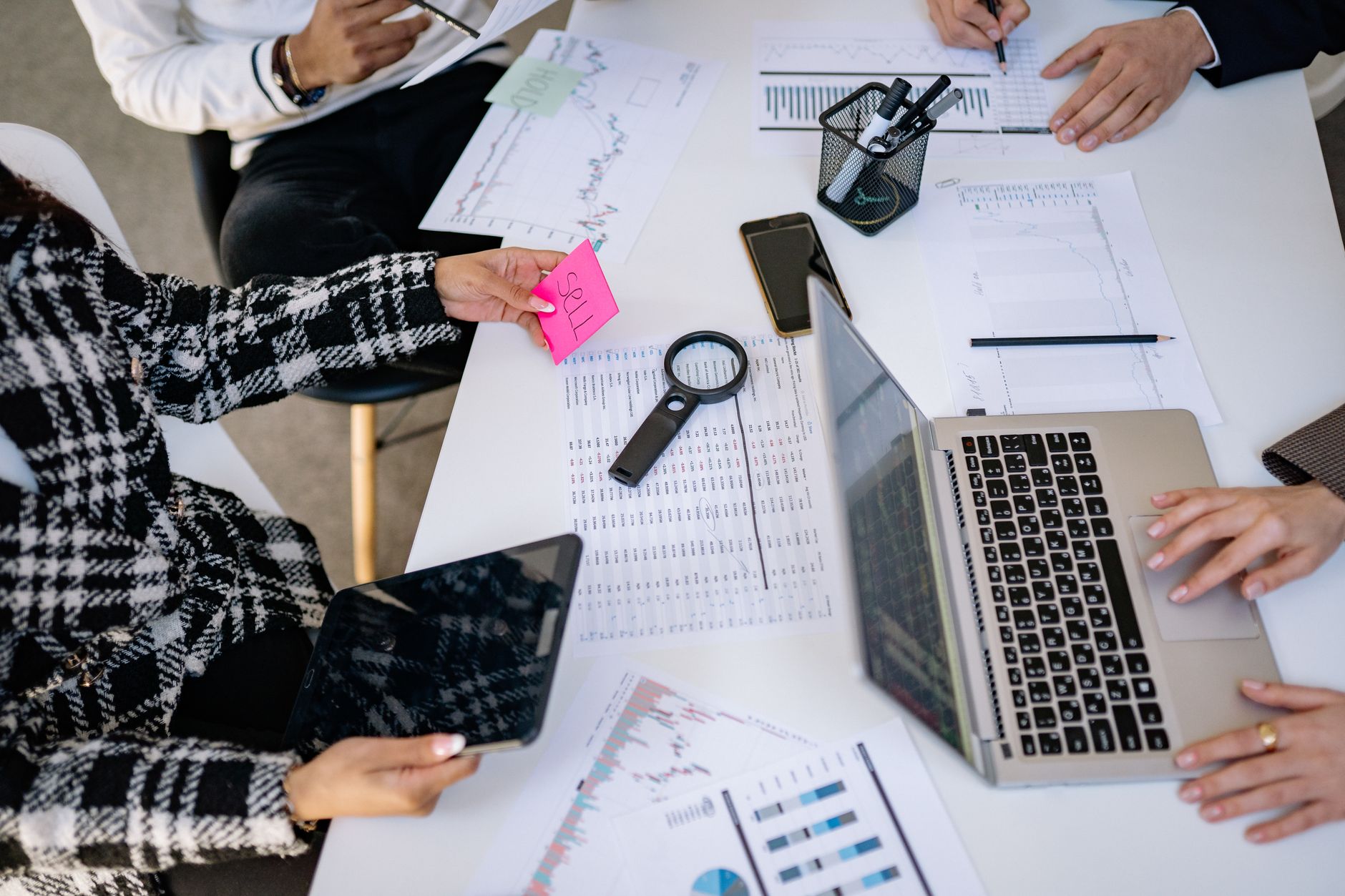 Research Methods for project management — Business professionals collaborating on financial data analysis in a modern office setting.