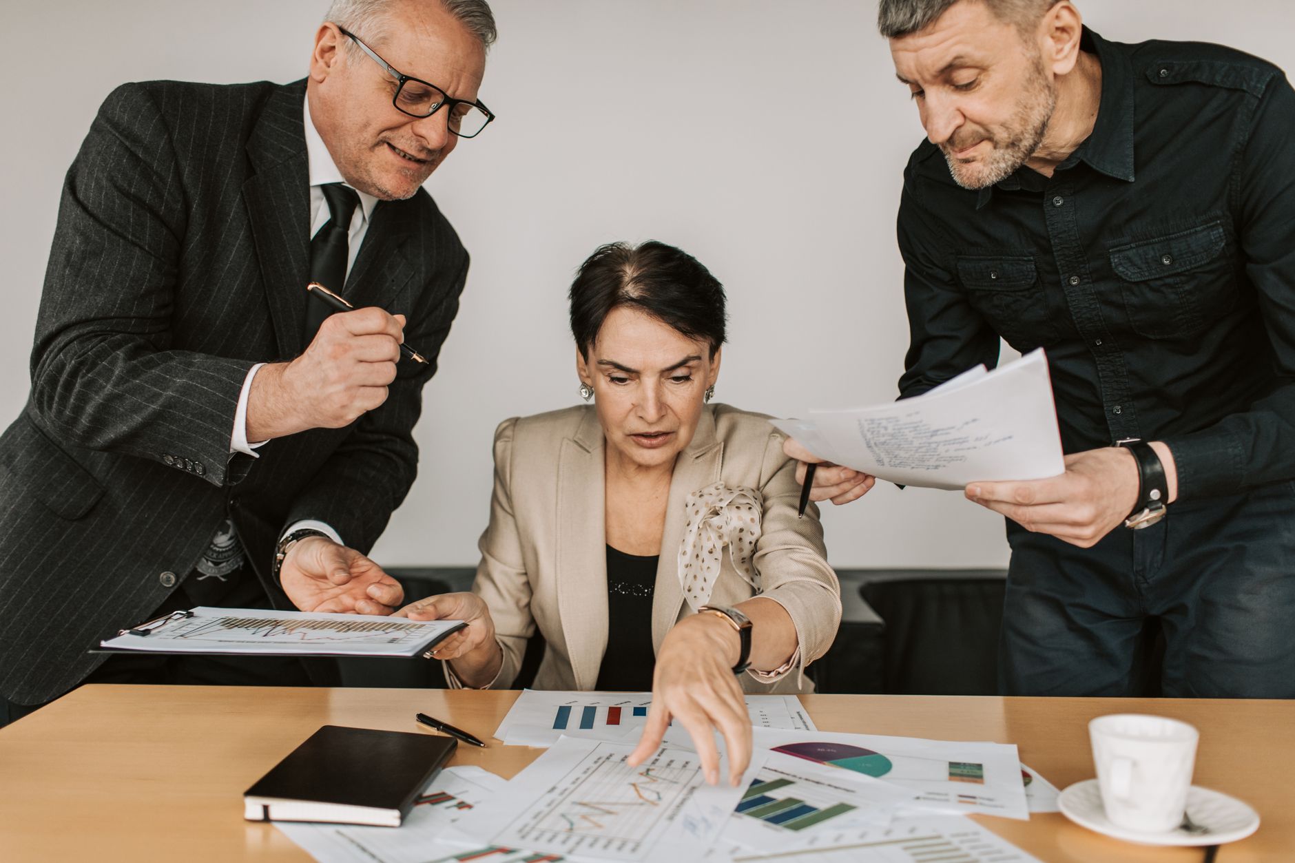 Strategic Risk Management — Business team collaborates on financial strategies during an office meeting. engaged discussion over reports.