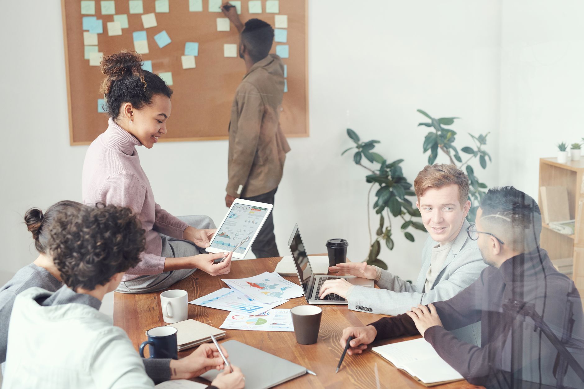Contemporary Challenges and Strategic Marketing — A diverse group of professionals discussing ideas in a modern office setting. perfect for business and teamwork concepts.