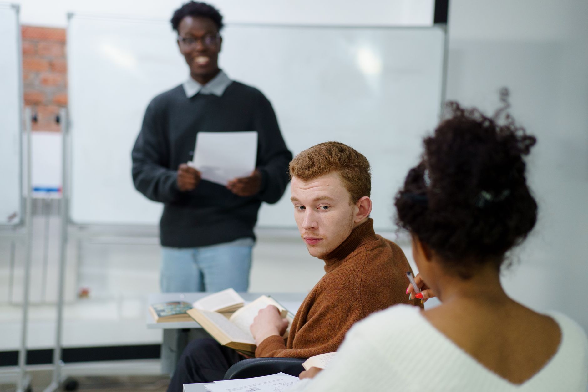 Communication — Students actively participating in a classroom discussion, fostering teamwork and learning.