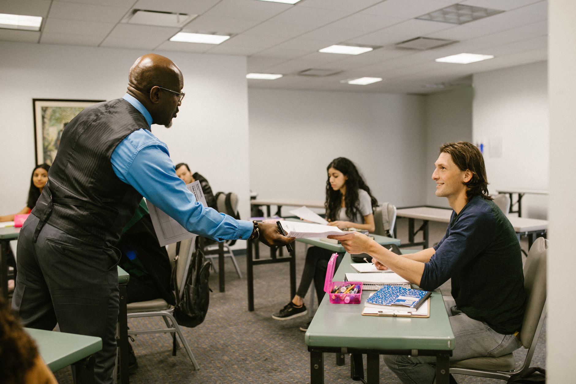 Awareness of Mental Health and Dementia — A teacher engaging with students in a university classroom, promoting active learning.