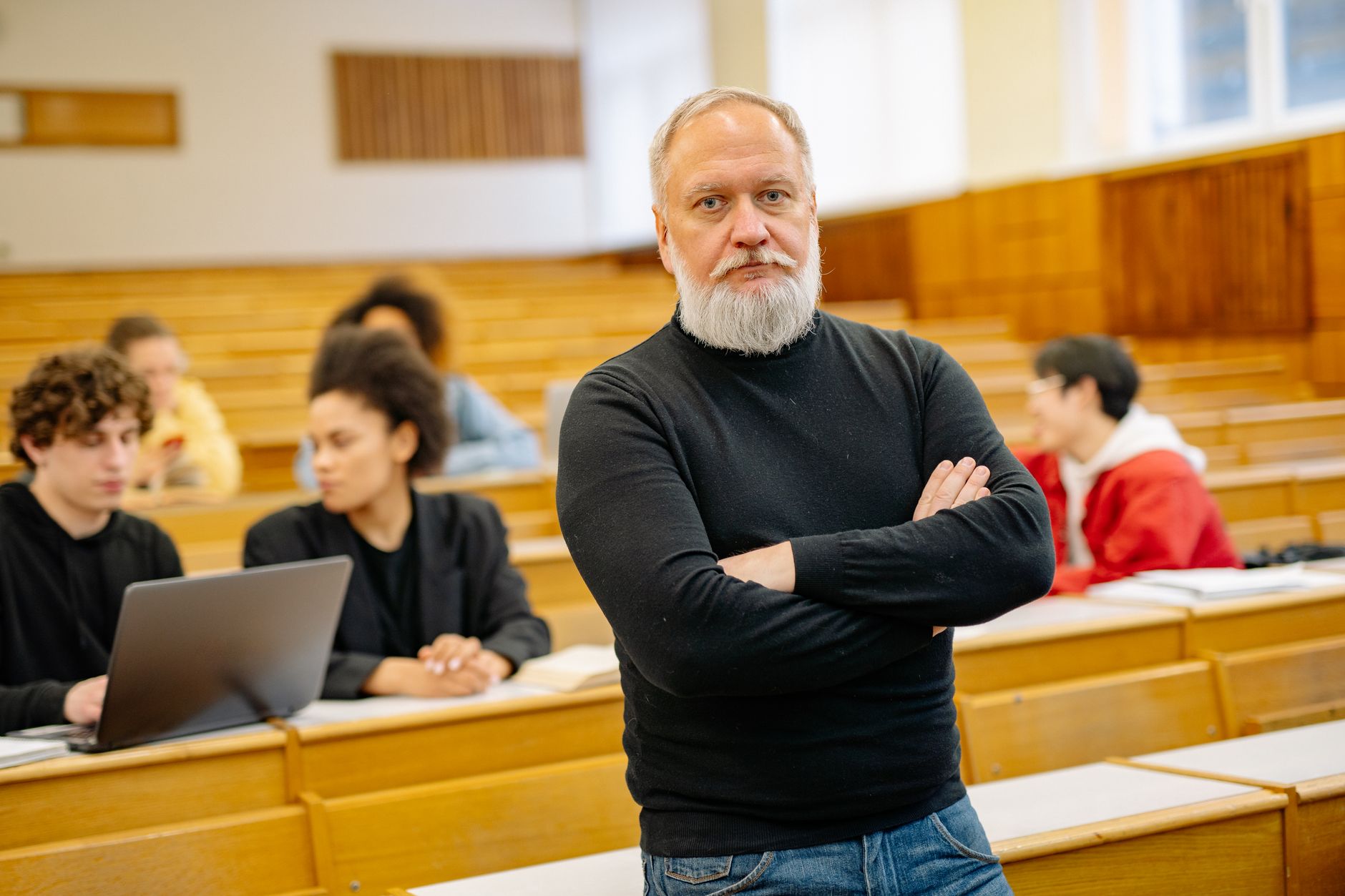 Communication for Health and Social Care — Confident professor in lecture hall with diverse students engaged in learning.