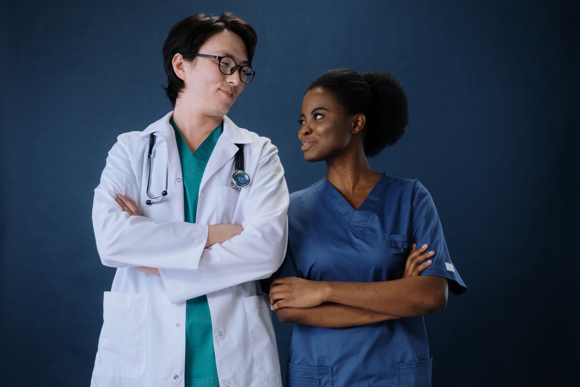 Principles Underpinning Health and Social Care — Diverse medical team in uniforms with stethoscopes, conveying teamwork and professionalism.