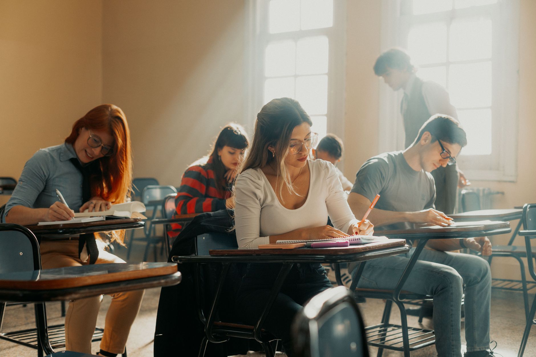Communication for Health and Social Care — Students studying in a sunlit buenos aires classroom, immersed in learning.