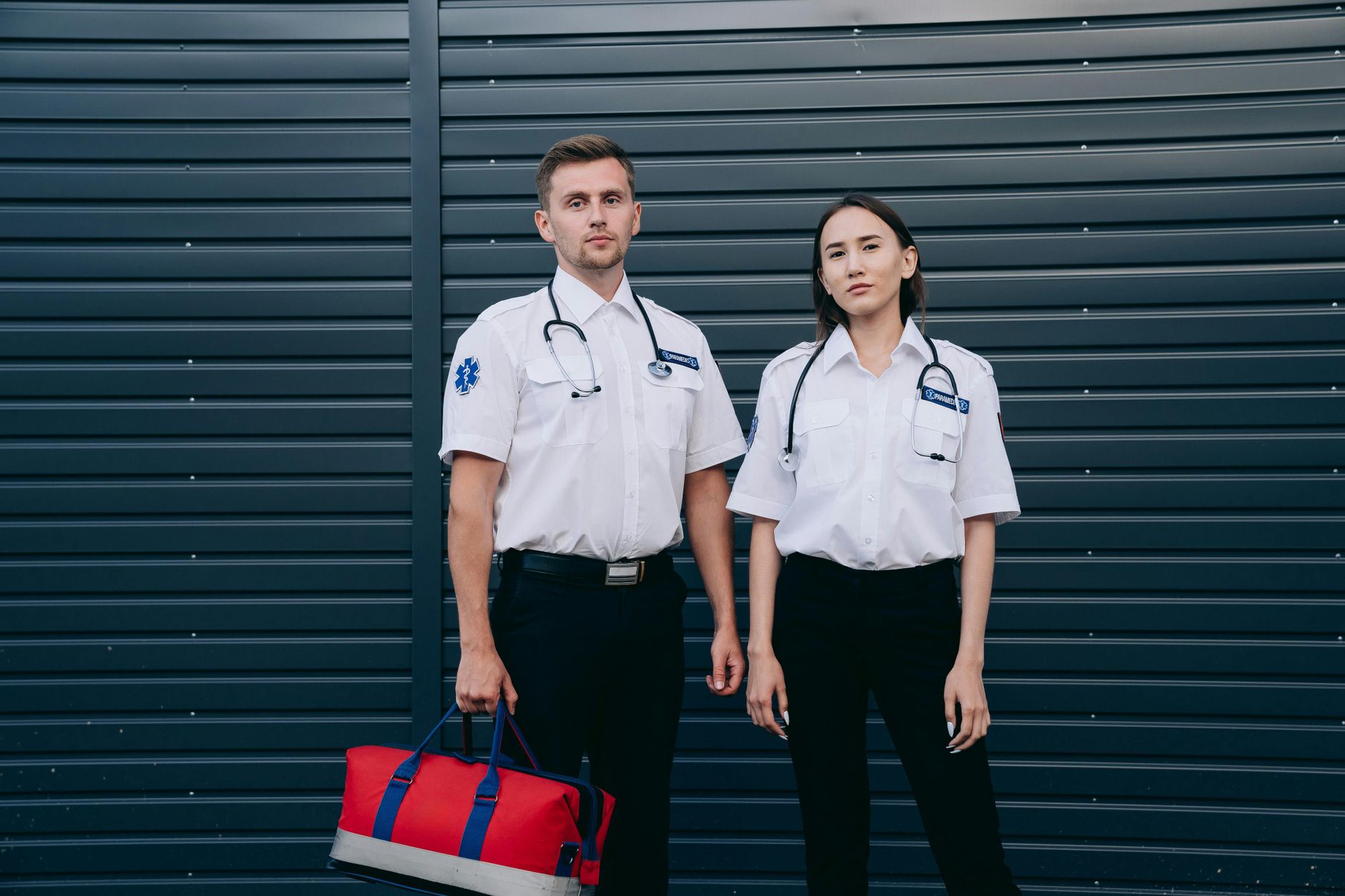 Partnership working in Health and Social Care — A confident pair of paramedics stand ready with medical equipment, exemplifying teamwork and professionalism.