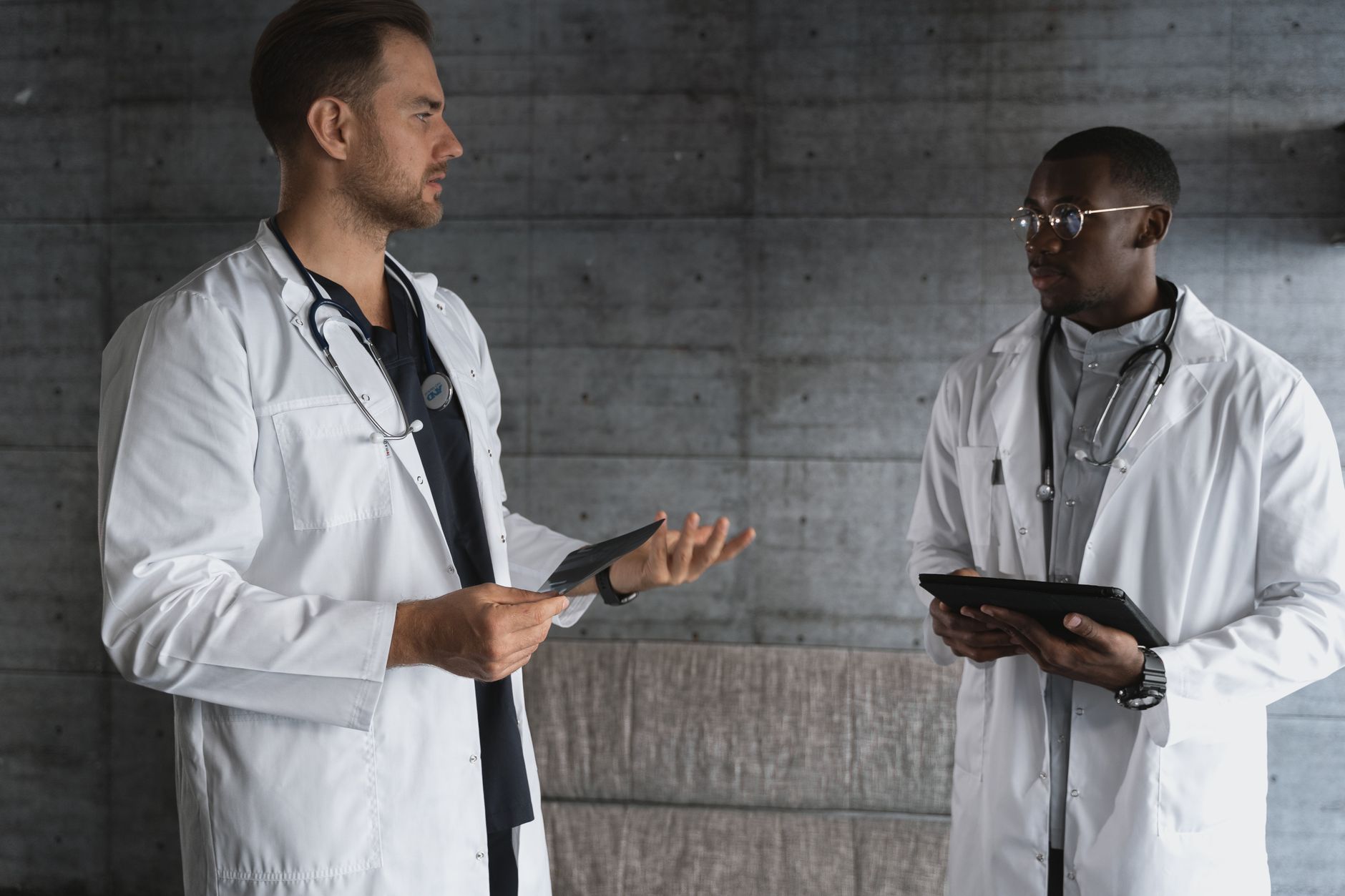 Health and Social Care Strategies and Policies — Two doctors in a modern workspace discussing patient care and medical research.