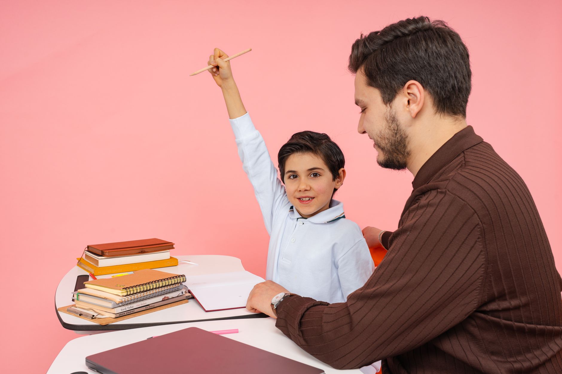 Processes Of Human Memory — Teacher aids enthusiastic student in classroom setting, enhancing learning experience.