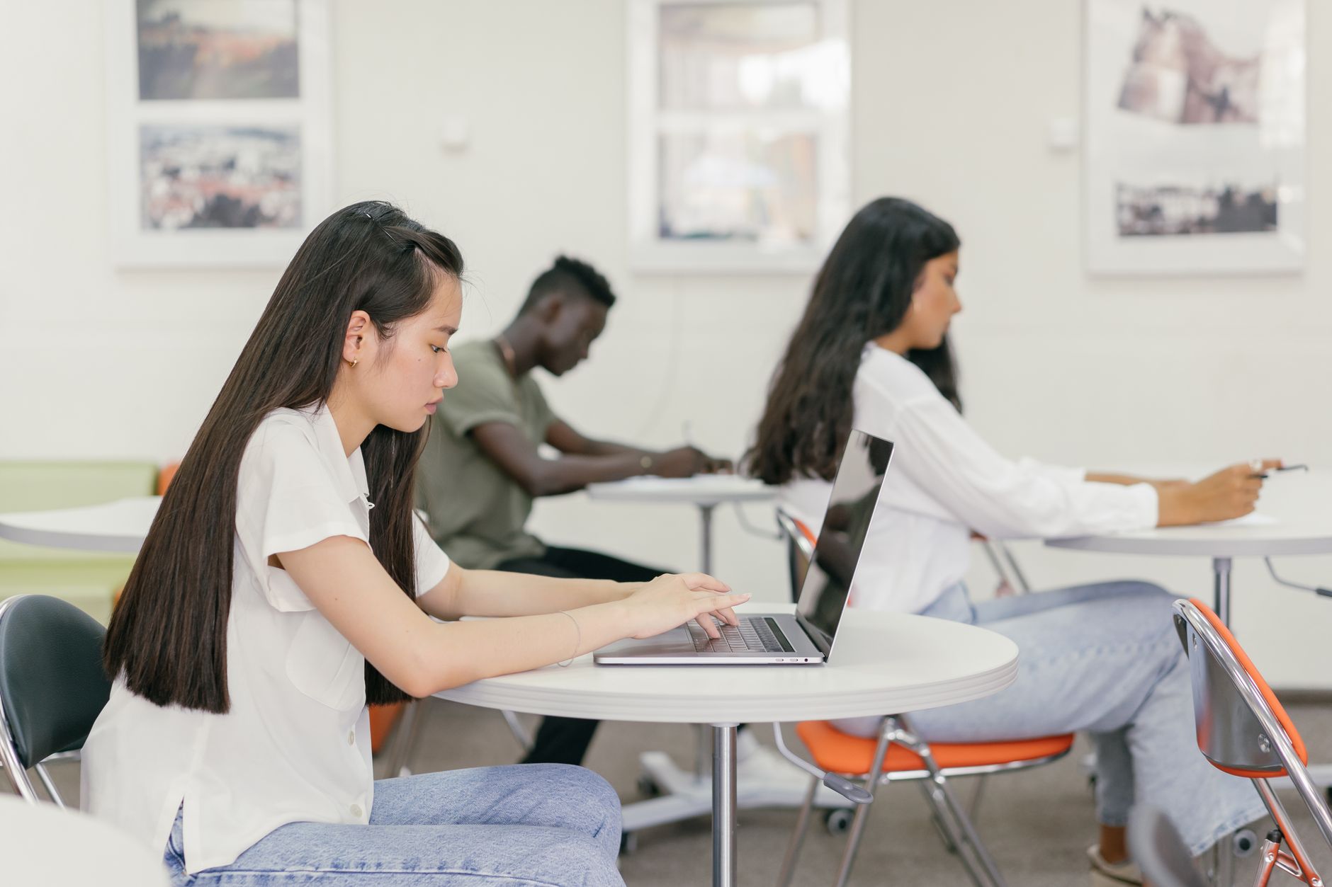 Individual Differences: Intelligence, Personality and Criminology — Students focused on learning in a contemporary university setting with laptops and notebooks.