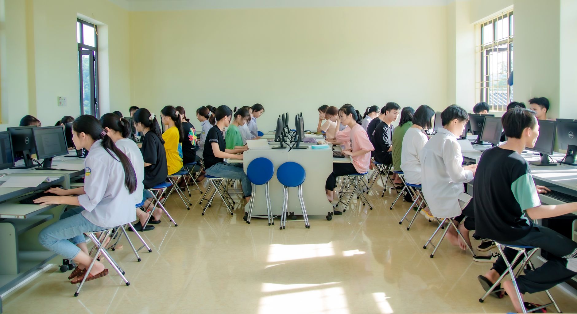 and then choose their subject area to complete another 120 credits. Units — Students engaging in a group study session at a university computer lab, focused and collaborative.