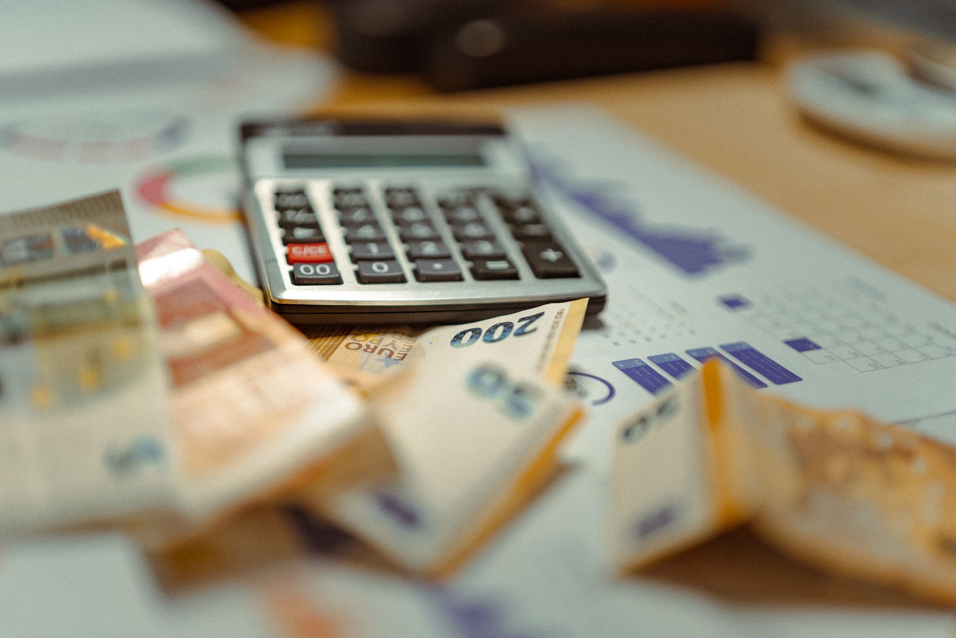 Management Accounting — Euro banknotes and calculator on financial documents, focusing on business budget planning.