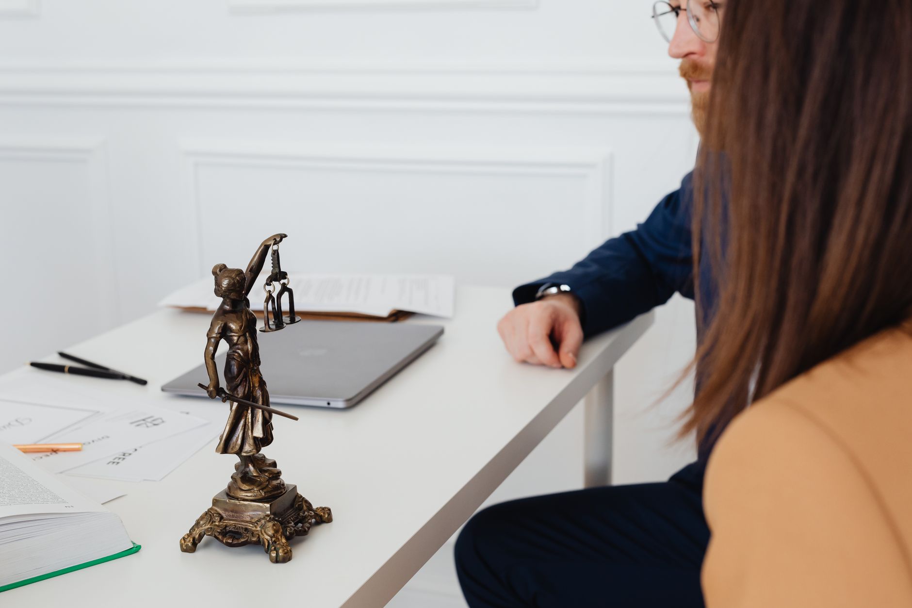 Company Law and Practice — Professional setting with lawyers and lady justice statue discussing legal documents.
