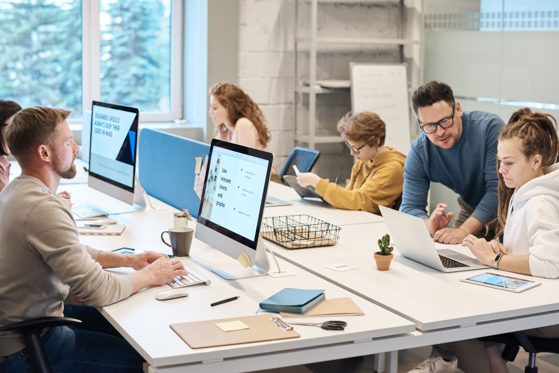 International Commercial Arbitration — Team collaboration in a modern office setting with computers and diverse employees working together.