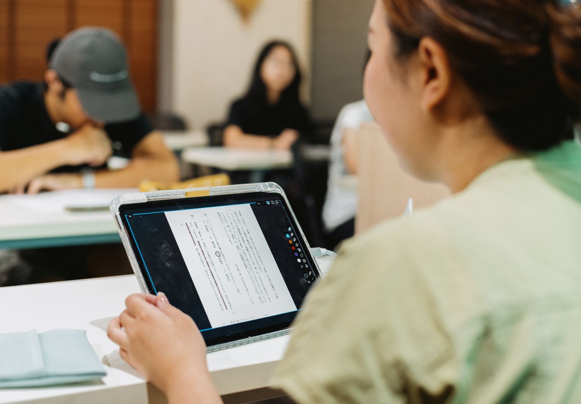 App End Application Development (Smart Home) — Students in a japanese classroom using a tablet for digital learning, fostering modern education.