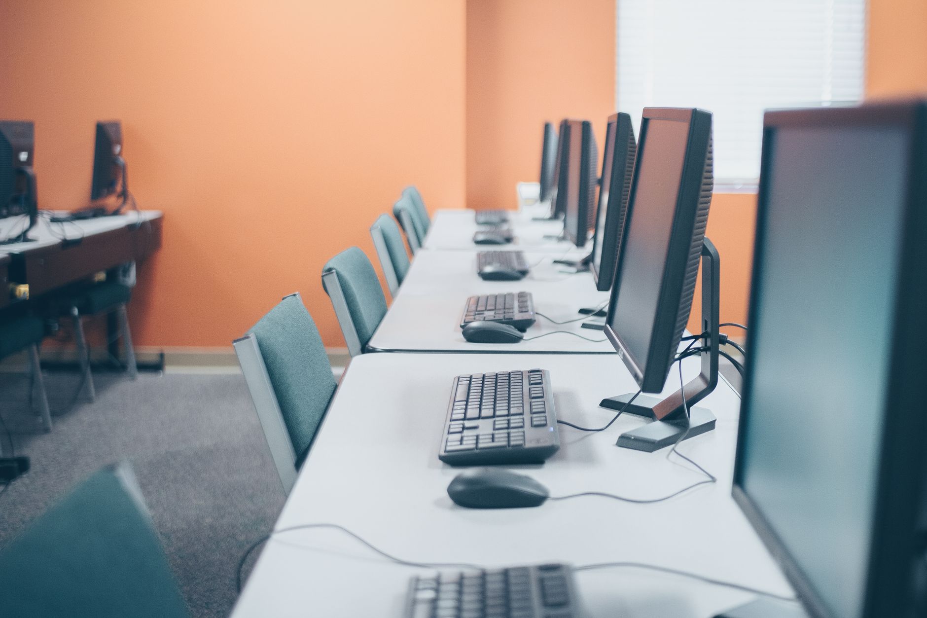 Elective Units — Contemporary style office with computers and keyboards near mouses on tables in light workspace