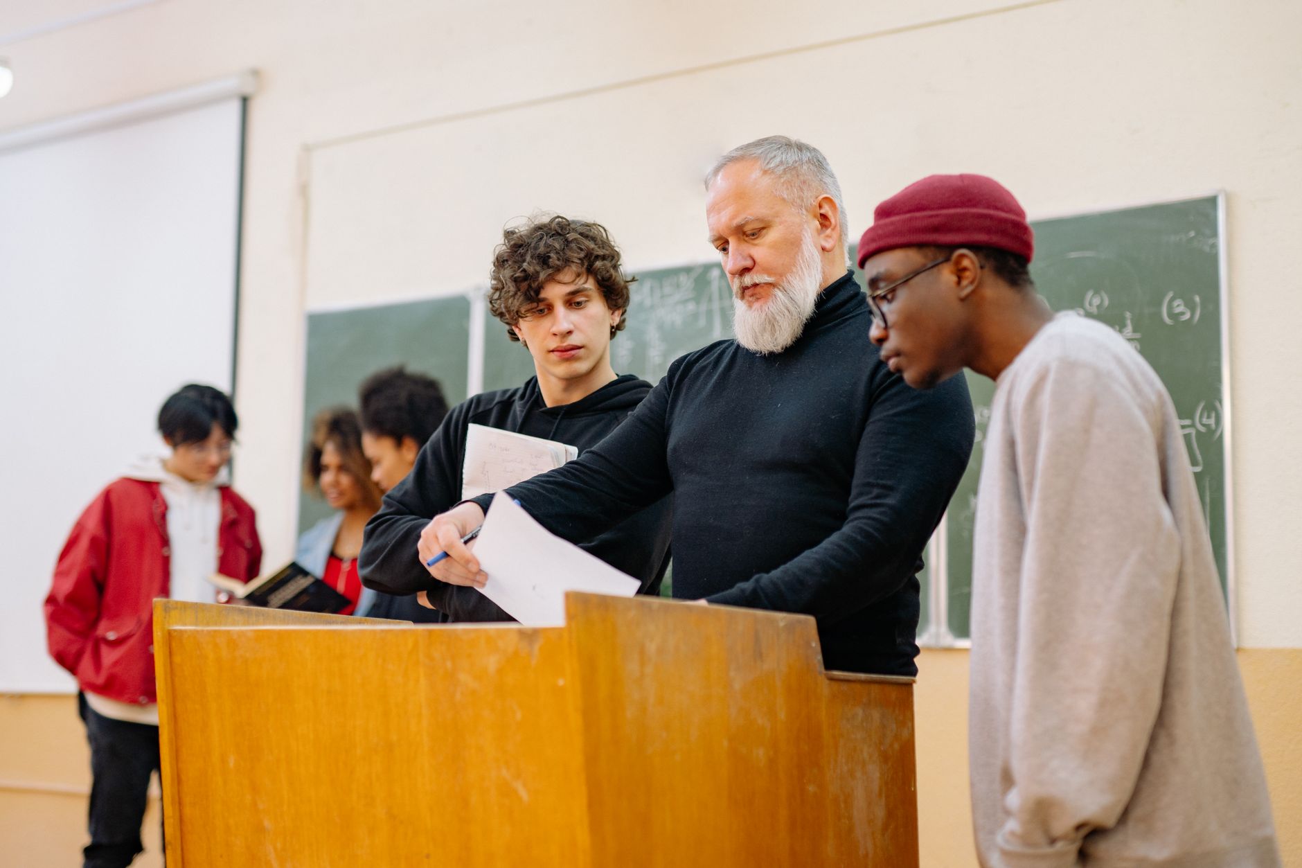 System Administration — Professor engages a diverse group of students in a university classroom setting, fostering learning and collaboration.
