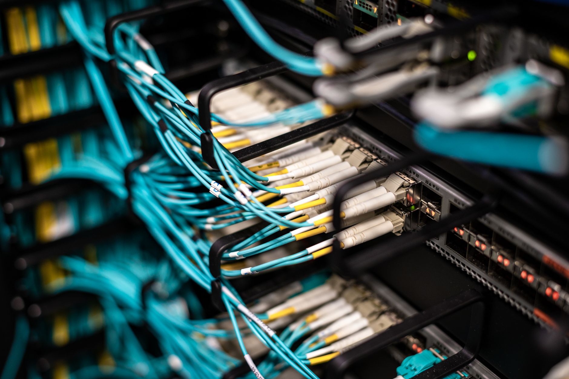 Network Design and Administration — Numerous wires and cables mounted into server patch panel in modern data center