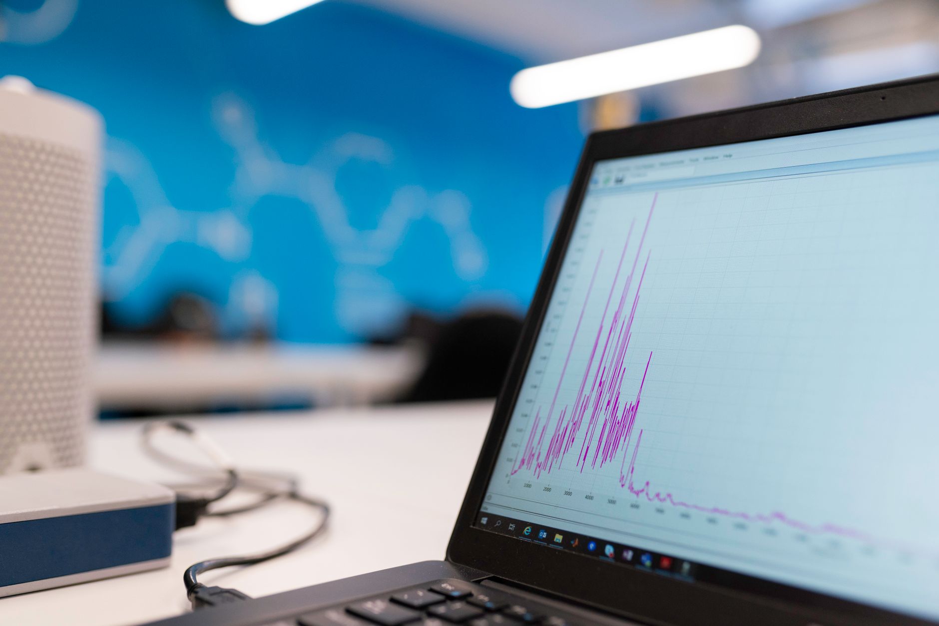 Data and Descriptive Statistics in Data Science — Laptop displaying data analytics graph in a modern office setting, symbolizing growth and technology.