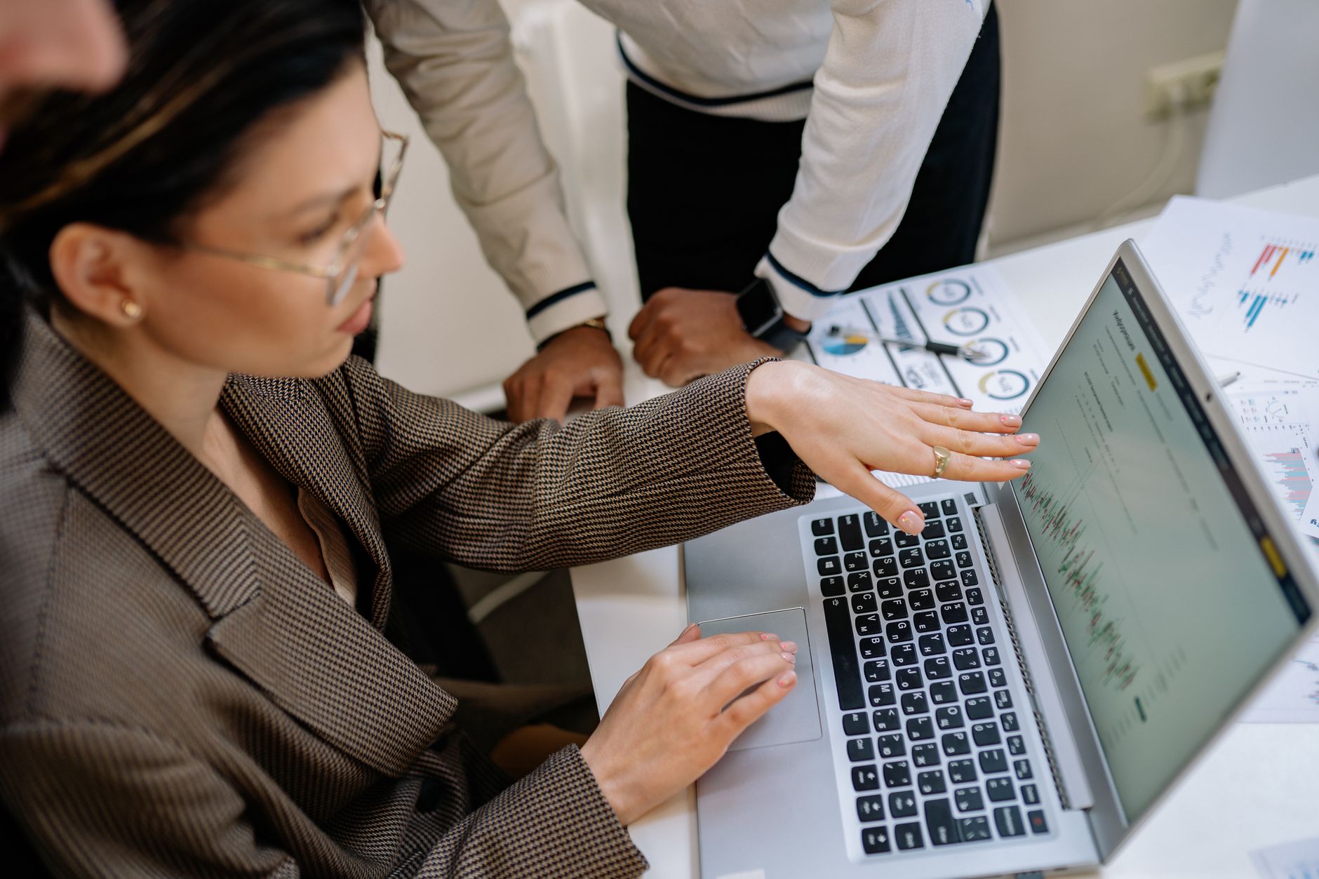 Decision Trees in Data ScienceK-means Clustering in Data Science — Two professionals focused on analyzing data charts on a laptop in an office setting.